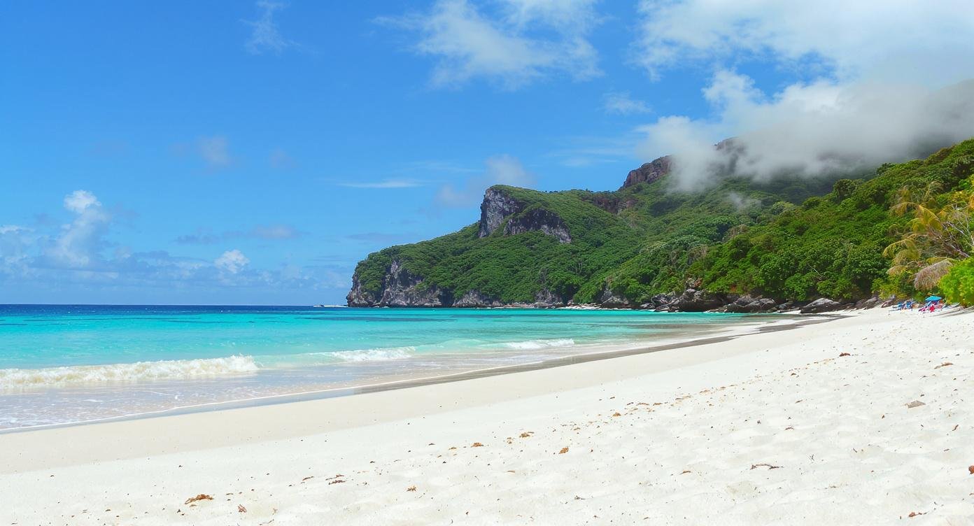 Flores vs Bali. Pristine empty white sand beach in Flores Indonesia with crystal clear turquoise sea and jungle hills — no people